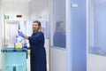 Happy female cleaner smiling in office