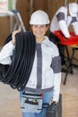 Happy female construction worker holding pipe at site Royalty Free Stock Photo