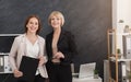 Happy female coworkers at workplace in office