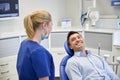 Happy female dentist with man patient at clinic Royalty Free Stock Photo