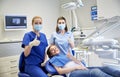 Happy female dentist with patient girl at clinic Royalty Free Stock Photo