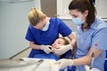 Happy female dentist with patient girl at clinic