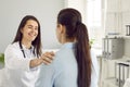 Happy female doctor congratulates her patient on recovery and reports good test results. Royalty Free Stock Photo