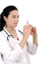 Happy female doctor looking at syringe Royalty Free Stock Photo