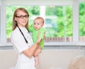 Happy female doctor pediatrician and patient child baby Royalty Free Stock Photo