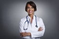 Happy female doctor studio portrait while standing at isolated background Royalty Free Stock Photo
