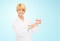 Happy female doctor with toothbrush and jaws model Royalty Free Stock Photo