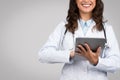 Happy female doctor using a digital tablet, free space Royalty Free Stock Photo