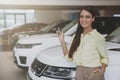 Happy woman holding car keys to her new automobile Royalty Free Stock Photo