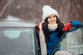 Happy Female Driver Standing By Her Car Admiring the Snow Royalty Free Stock Photo