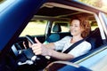 Happy female driver steering car with safety belt Royalty Free Stock Photo