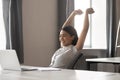 Happy female employee stretch in chair finishing work Royalty Free Stock Photo