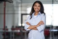 Portrait of a young happy attractive business woman or female office worker keeping arms crossed, looking at camera and Royalty Free Stock Photo