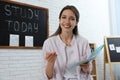 Happy female English teacher giving lesson in elementary school Royalty Free Stock Photo