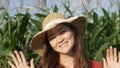 A happy female farmer on a maize field in the rural area. Cheerful country woman on a corn plantation. Student working