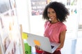Happy female fashion designer using laptop in design studio Royalty Free Stock Photo