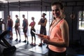 Happy female fitness instructor holding clipboard Royalty Free Stock Photo