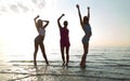 Happy female friends dancing on beach Royalty Free Stock Photo