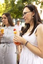 Happy female friends spending time together, young woman drinking Aperol spritz cocktail