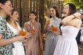 Happy female friends spending time together, young woman drinking Aperol spritz