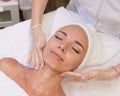 Happy female getting facial massage alternative medicine top view