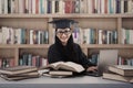 Happy female graduate study at library with laptop Royalty Free Stock Photo