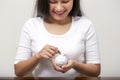 Happy female hand putting money into piggy bank for saving money Royalty Free Stock Photo