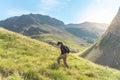 Happy female hiker trekking climbing a mountain. Effort and achievement concept. Royalty Free Stock Photo