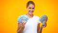 Happy female holding dollar banknotes, financial success, wealth earnings income Royalty Free Stock Photo