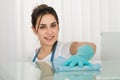 Happy Female Janitor Cleaning Desk With Rag Royalty Free Stock Photo