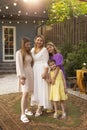 Happy female parent with children, celebration in the garden