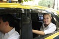 Happy female passenger inside of a taxi