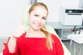 Happy female patient at dentist showing thumb-up Royalty Free Stock Photo