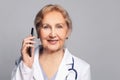 Happy female physician or surgeon gives prescription via mobile phone, closeup portrait Royalty Free Stock Photo