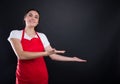Happy female with red apron invinting you in