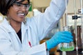 Happy female researcher in chemical lab