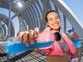 Happy female runner with energetic drinks for hydration