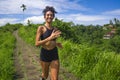 Happy female runner training on countryside road - young attractive and fit jogger woman doing running workout outdoors at Royalty Free Stock Photo