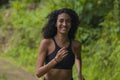 Happy female runner training on countryside road - young attractive and fit jogger woman doing running workout outdoors at Royalty Free Stock Photo