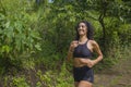 Happy female runner training on countryside road - young attractive and fit jogger woman doing running workout outdoors at Royalty Free Stock Photo