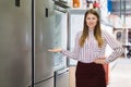 female seller showing refrigerator