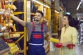 Happy female shopper in building materials store chooses tools for home make repairs. Royalty Free Stock Photo