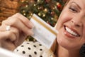 Happy Female Shopper Holding Credit Card By Christmas Tree