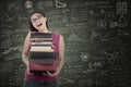 Happy female student bring books at class