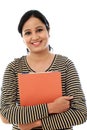 Happy female student holding text book Royalty Free Stock Photo