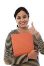 Happy female student holding text book Royalty Free Stock Photo