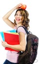 Happy female student with red apple above her head isolated on w Royalty Free Stock Photo