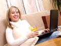 Happy female student working on her computer. Royalty Free Stock Photo