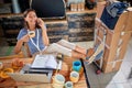 Happy female talking on her cell phone and drinking coffee with her legs on the table. casual, relaxed, break, pause