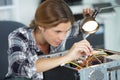 happy female technician repairing computer